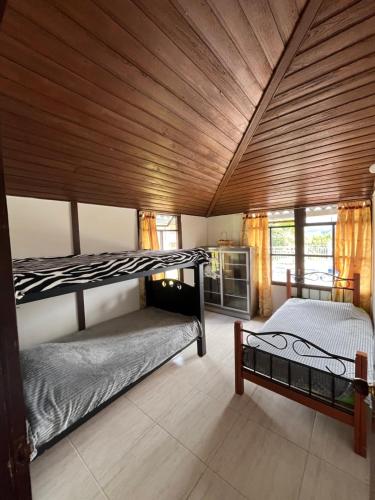 two bunk beds in a room with a wooden ceiling at Villa Del Viento in Calima