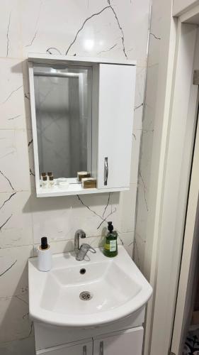 a bathroom with a white sink and a mirror at Balat Life Suites in Istanbul