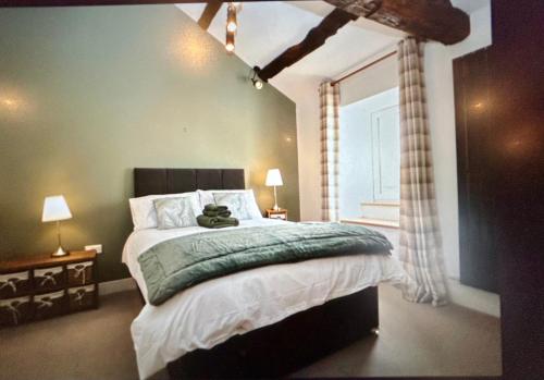 a bedroom with a bed with a teddy bear on it at Bakers Cottage in Cockermouth