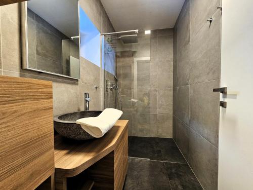 a bathroom with a sink and a shower at ChaletSKI Jasná, SKI-IN & SKI-OUT in Belá