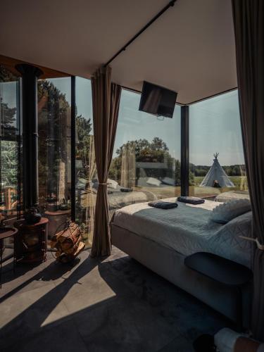 a bedroom with a bed and a large window at Kihnuvillas - Männirahu in Linaküla