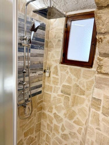 a bathroom with a shower with a window at Mare' in Vieste