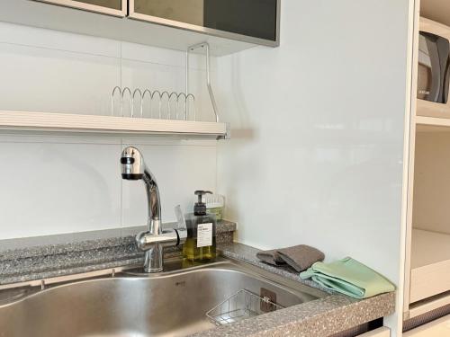 a kitchen sink with a faucet on top of it at Ansik in Busan