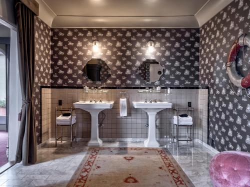 a bathroom with two sinks and two mirrors at Maison Twenty Seven in Los Angeles