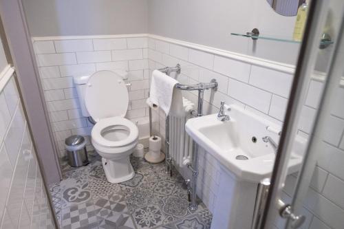 a bathroom with a toilet and a sink at The Milestone in Sowerby Bridge