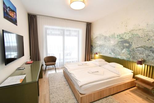 a bedroom with a large white bed in a room at Angyal Villa in Rátka