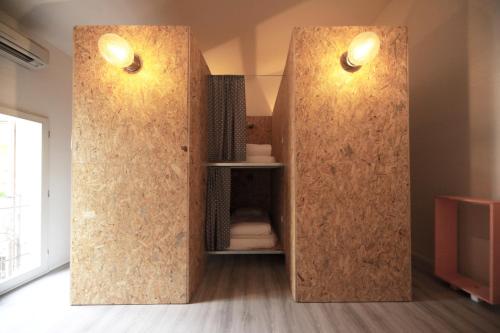 a room with a partition with two lights on at Dopa Hostel in Bologna