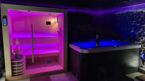 a purple bathroom with a tub and a sink at Les Murmures du Rhône - Appartement Cosy et Lumineux in Andance