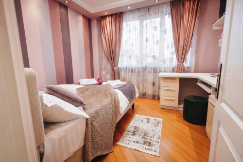 a small room with two beds and a sink at Downtown Cozy Retreat - parcare inclusa in Vatra Dornei