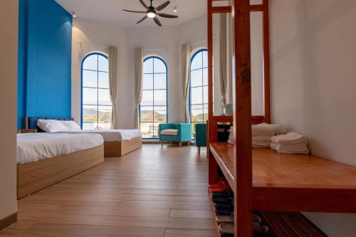 a bedroom with two beds and a mirror at Santonita Hotel & Tours in Ninh Hải