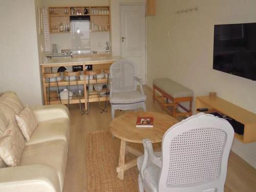 a living room with a couch and a table at King Fisher 6 in Mossel Bay