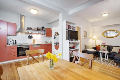 a kitchen and living room with a table and chairs at Brauhaus am See in Gartow