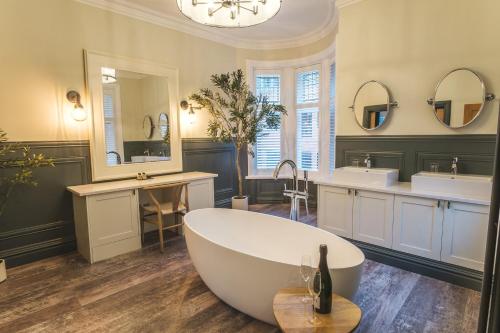 a large bathroom with two sinks and a tub at The Fleece Hotel Richmond in Richmond