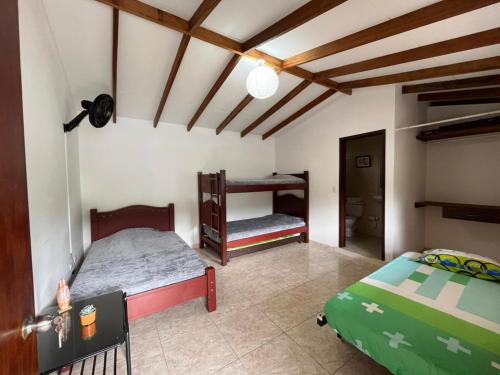 a bedroom with two beds in a room at Lago Calima Hostel in Calima