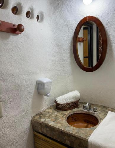 a bathroom with a sink and a mirror at Cabañas Sierra Gorda in Jalpan de Serra