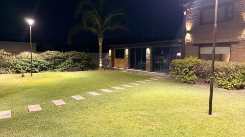 a grassy yard with a house at night at Casa Ruta 1 in San José