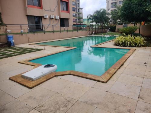 a swimming pool with a frisbee in the middle at Apartment in Igatpuri! in Igatpuri