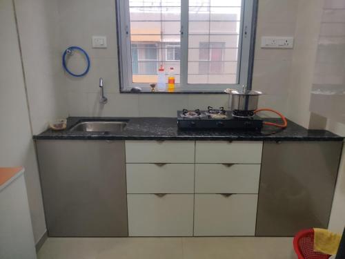 a kitchen with a sink and a counter top at Apartment in Igatpuri! in Igatpuri