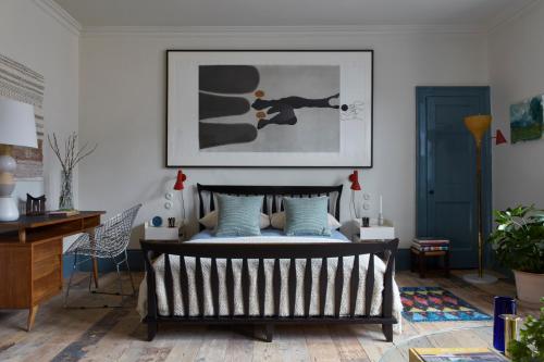 a bedroom with a bed with a picture on the wall at 8 Holland Street Townhouse Bath in Bath