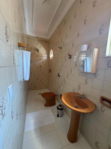 a bathroom with a sink and a toilet at Hotel Samaritano in Montes Claros