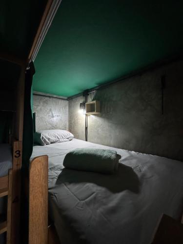 a bedroom with a bed with a green ceiling at Book a bed Jacumã in Conde