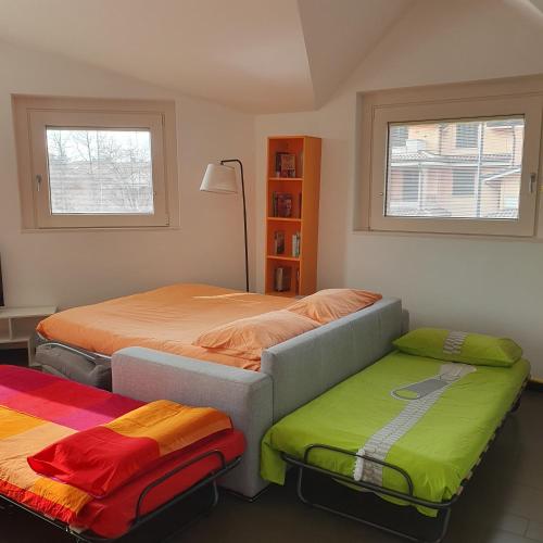 a bedroom with two beds and two ottomans at B&B Casa Sara in Cassano dʼAdda
