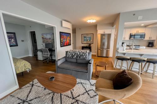 a living room and kitchen with a couch and a table at Serene in Seattle in Seattle