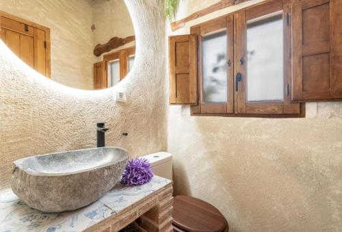 a bathroom with a stone sink and a mirror at El Kubo in Olba