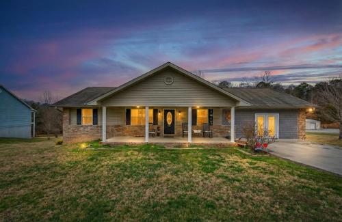 a house with a driveway and a house at Sunshine Cottage Hot Tub Game Room Grill MORE in Sevierville