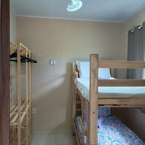 a room with two bunk beds in a room at Paim`s Village Itacaré in Itacaré