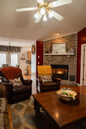a living room with a couch and a fireplace at Sunshine Cottage Hot Tub Game Room Grill MORE in Sevierville