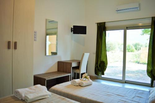 Postel nebo postele na pokoji v ubytování La Maison di Zia Annina Olbia Costa Smeralda