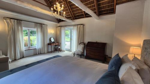 a large bedroom with a large bed and a window at Coppull Private Nature Reserve in Stanford