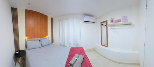a small bedroom with a bed with a red blanket at Loftt concept in Rio de Janeiro