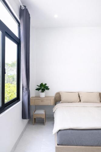 a bedroom with two beds and a window at The One Apartments in Tân Uyên