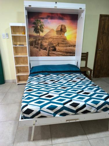 a bed in a room with a poster on the wall at Casa quinta La Ruchi in San Andrés de Giles