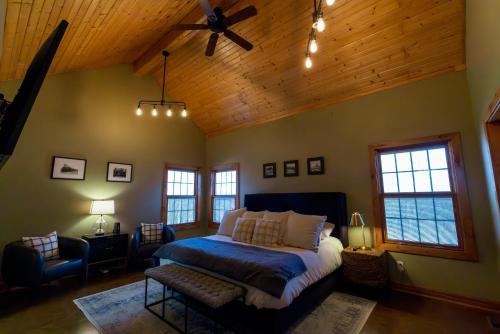 a bedroom with a bed and a wooden ceiling at The Train Station in Salina