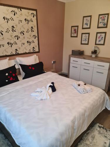a bedroom with a bed with two towels on it at Casa & Julieta in Tecuci