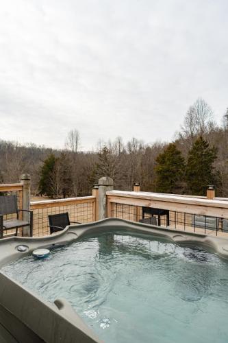 a large hot tub on a patio with a fence at Sunshine Cottage Hot Tub Game Room Grill MORE in Sevierville