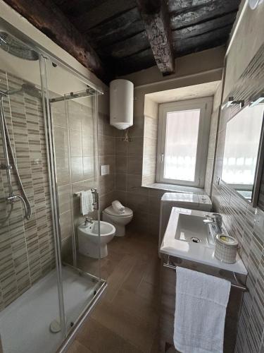 a bathroom with a shower and a sink and a toilet at Casetta n'da civita in Castrovillari