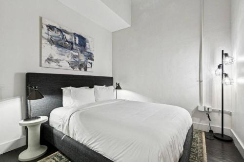 a bedroom with a large white bed in it at Ther Gregory Suite 101 ADA in New Orleans