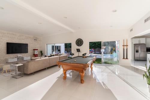 a living room with a pool table and a couch at Miami Villa with Heated Pool Luxury Stay in North Miami Beach
