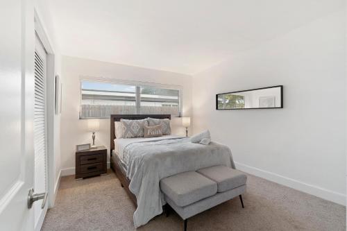 a white bedroom with a bed and a window at Miami Villa with Heated Pool Luxury Stay in North Miami Beach