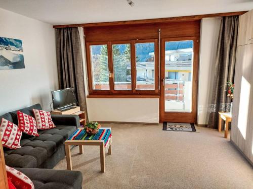 a living room with a couch and a table at Apartment Orion by Interhome in Leukerbad
