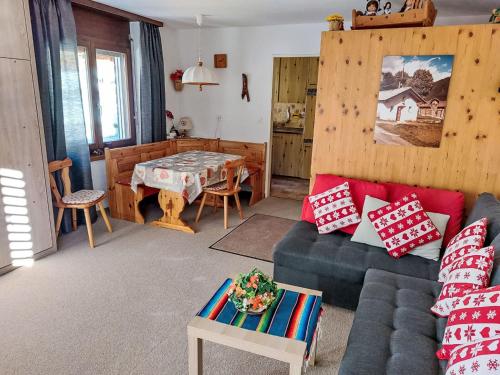 a living room with a couch and a table at Apartment Orion by Interhome in Leukerbad