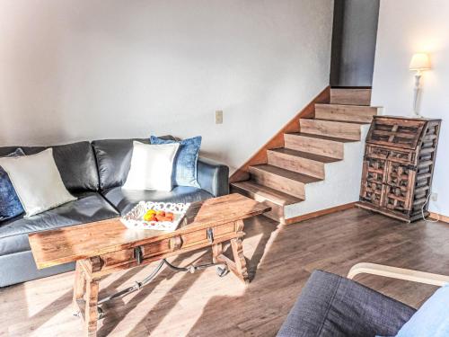 a living room with a couch and a table at Apartment Villars Soleil A27 by Interhome in Villars-sur-Ollon