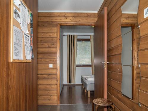 a hallway with wooden walls and a door and a window at Holiday Home Villa ylläs 201 by Interhome in Ylläs