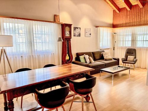 a living room with a large wooden table and chairs at Apartment Diana by Interhome in Münster