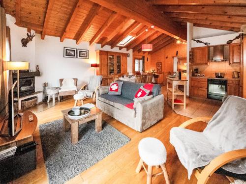 a living room with a couch and a table at Chalet Ropiar by Interhome in Ovronnaz