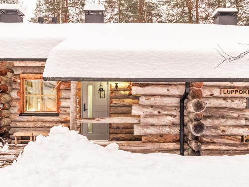 a log cabin in the snow at Holiday Home Luppokero 2 by Interhome in Pyhätunturi